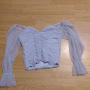 Light blue women's shirt. Poofy sleeve/sheer.